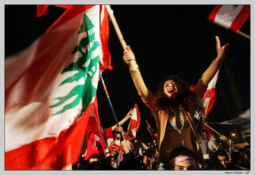 Lebanese flag-waving protestors.  © AP / Kevin Frayer.