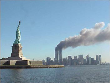 View of the Statue of Liberty as seen from the water on the morning of September 11, 2001 with the World Trade Center towers in the New York Skyline.  Photo: National Park Service.  http://www.nps.gov/remembrance/statue/